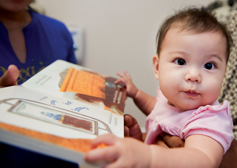 Infant Reading an Early Childhood Book