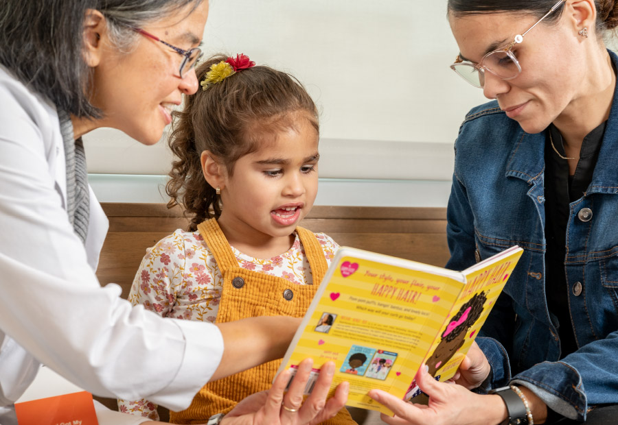 Two Mom's Reading to Daughter