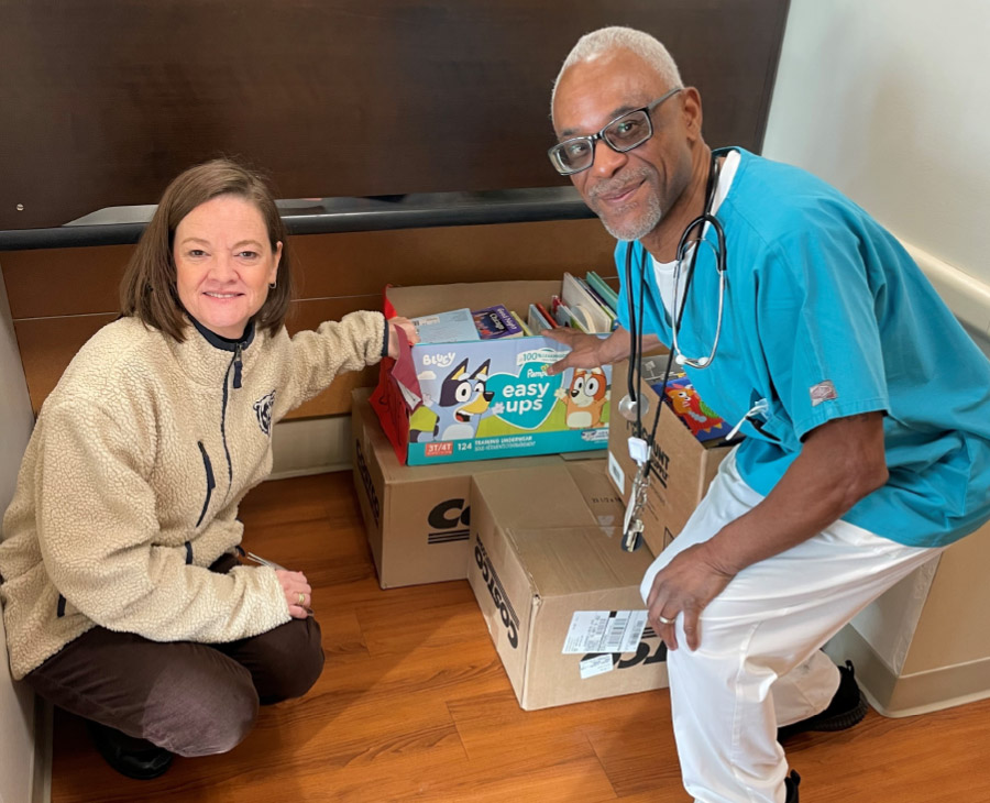 Two People who ran a book drive looking at donated books