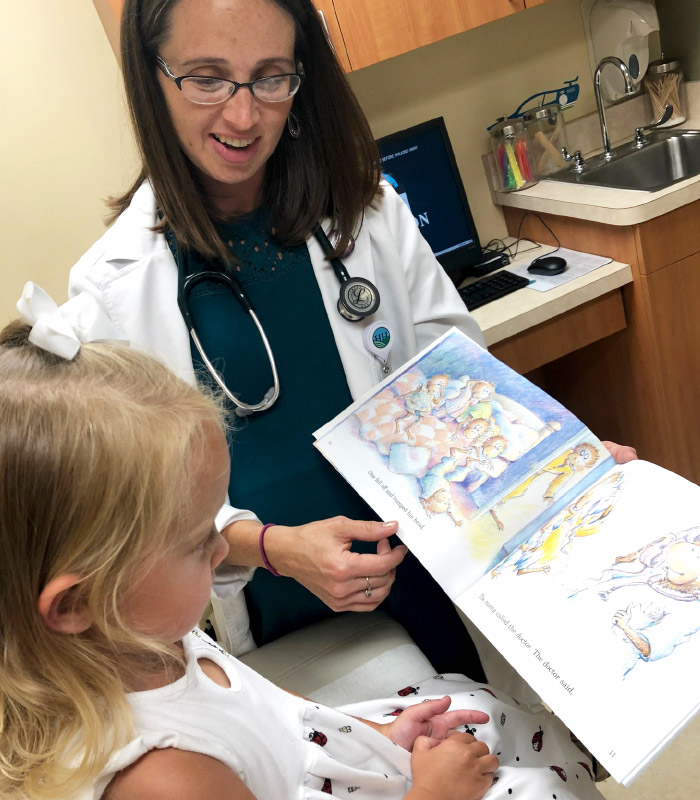 Doctor Showing a Book to a Child
