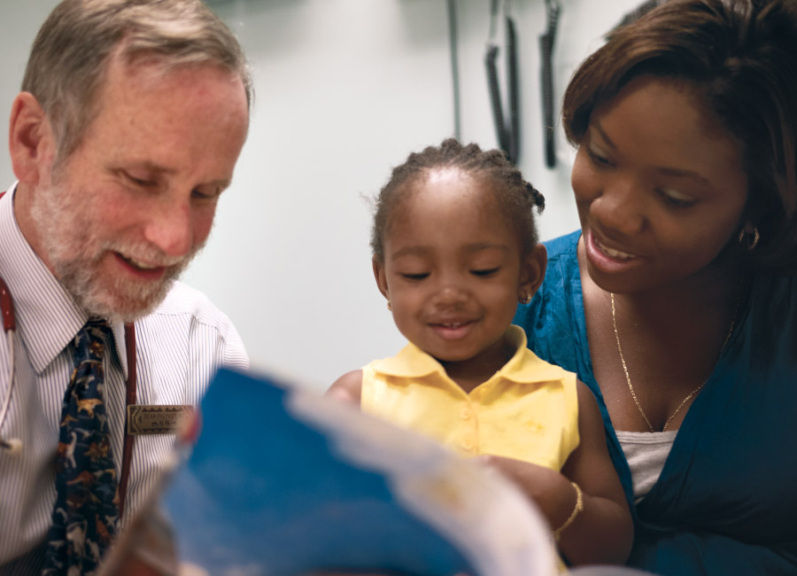 Doctor and Mom Reading to a small child