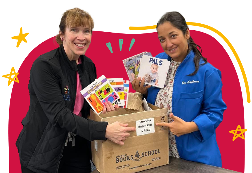 Two Women Holding a Box of Books